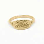solid gold word ring engraved with 'Worthy' in script font on a white background